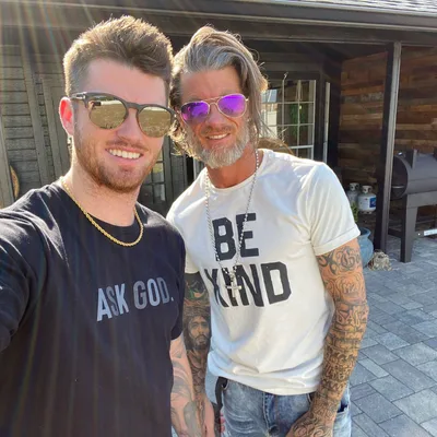 A FATHER AND HIS SON DISCUSSING  THE FATHER